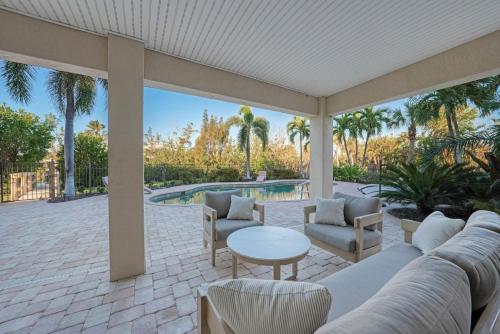 a patio with a couch and chairs and a table at Dockside Dream at Ding Darling in Sanibel
