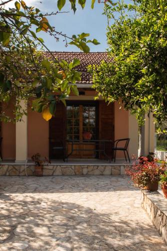 a porch of a house with a patio at Anthoula's garden apartments in Perivolion