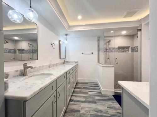 a bathroom with a sink and a shower at Kings Crown 118 in Sanibel