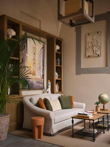 a living room with a couch and a table at Collegio alla Querce, Auberge Collection in Florence