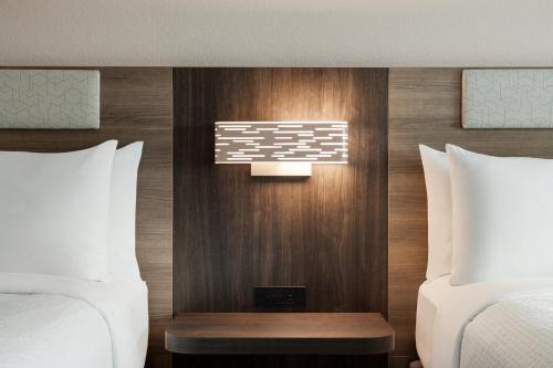 a hotel room with two beds and a window at Holiday Inn Express Baltimore At The Stadiums by IHG in Baltimore