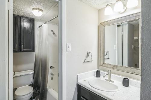 a bathroom with a sink and a toilet and a mirror at C Springs 614 I Spacious 1 Bed 1 Bath in Bedford
