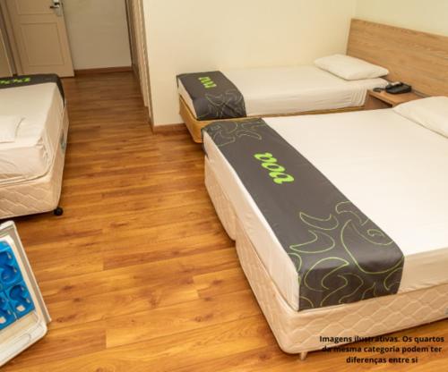 Postel nebo postele na pokoji v ubytování VOA Hotel Caxambu
