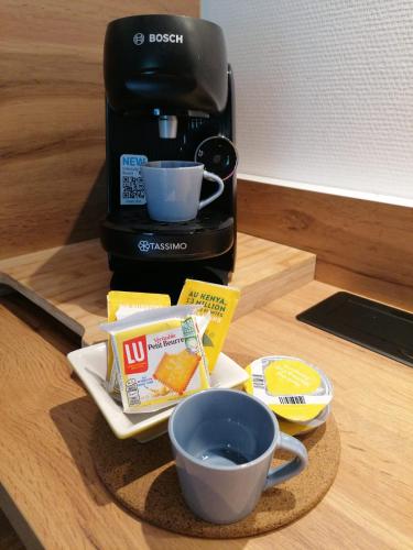 - une cafetière avec une tasse de café sur une table dans l'établissement Appartement cosy avec terrasse, à Nantes