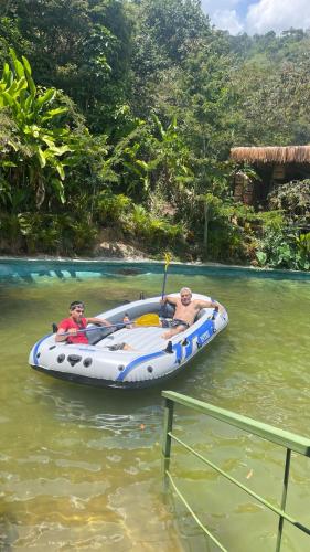 two people in a speed boat on the water at ANCESTRAL GLAMPING in Barbosa