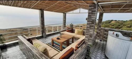 a balcony of a house with a view of the ocean at Blue ocean villa in Asilah