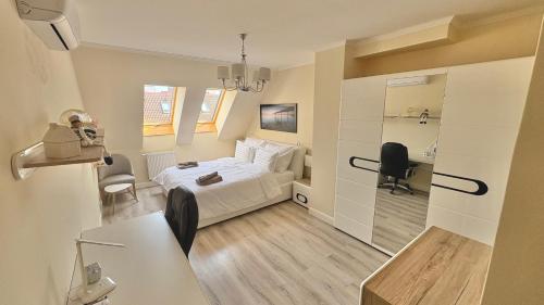 a bedroom with a bed and a desk with a chair at Dandár Family Residence Free Parking in Budapest