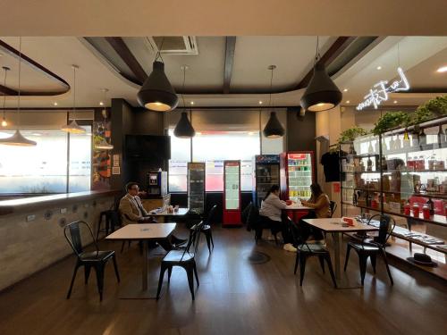 a group of people sitting at tables in a restaurant at ibis Santiago Estacion Central in Santiago