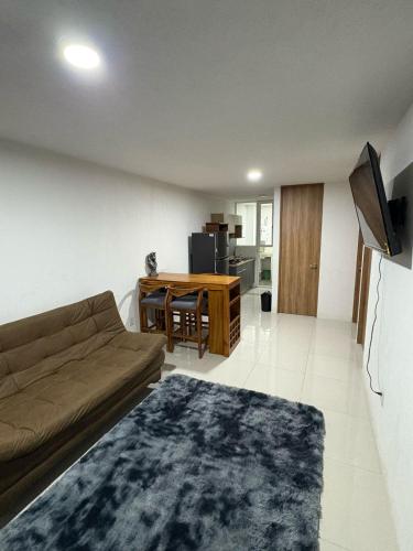 a living room with a couch and a table at Altos de GDL in Guadalajara