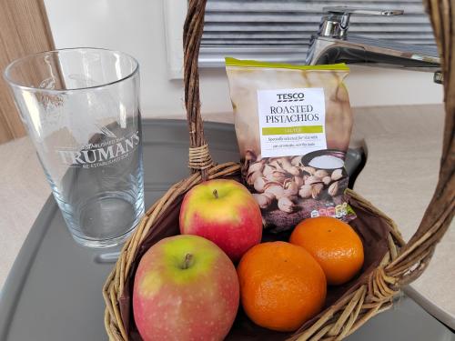 a basket of fruit and nuts on a table at Country Roost in High Wycombe