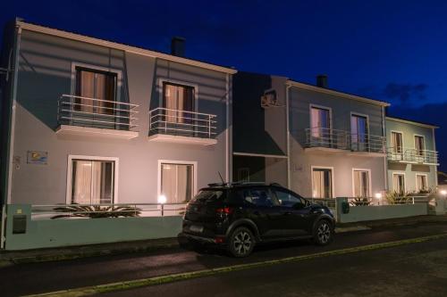 a car parked in front of a building at night at Areal de Santa Bárbara Sea View in Ribeira Grande