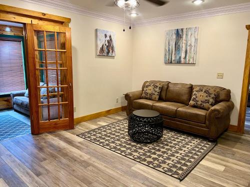 a living room with a couch and a table at Sleeps 22, mountain view, game room, pet friendly! in Sevierville