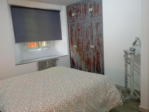 a bedroom with a bed and a window and a television at La Casona de Betanzos in Betanzos