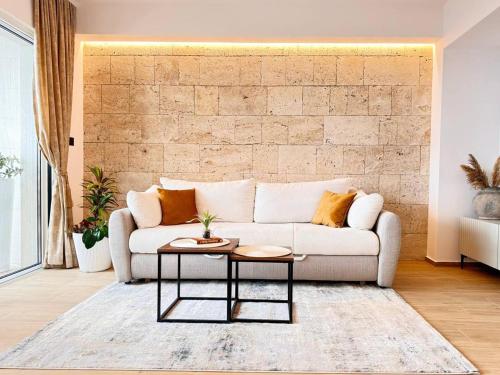 a living room with a couch and a table at Apartmani Nikola in Baška Voda
