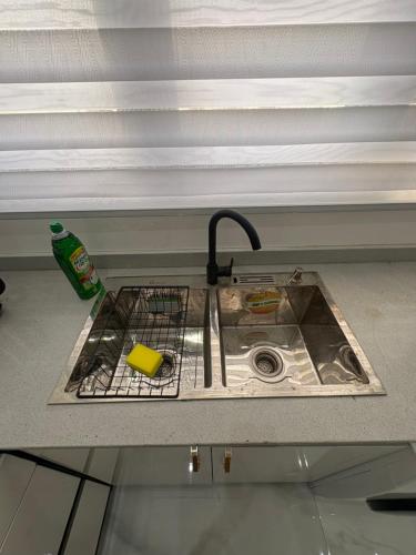 a kitchen sink with a faucet and a sink at Nest apartments in Lekki