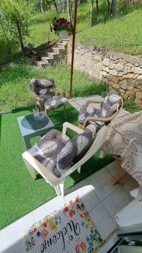 a group of chairs sitting on the grass at Vila Raj in Gornja Toplica