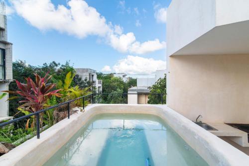 una piscina sul balcone di un edificio di 2-BR Aldea Zama Sanctuary of Tulum a Tulum