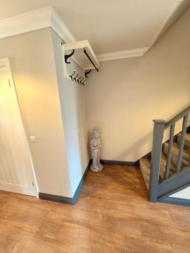 a room with a staircase and a stair case at Spacious 3 Bedroom House in Wool in Wool