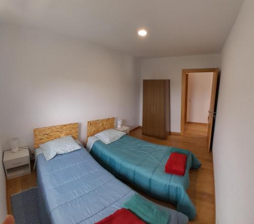a room with two beds and a hallway at T1TR Anciao in Ancião