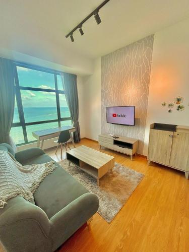 a living room with a couch and a television at imperium residence kuantan in Kuantan