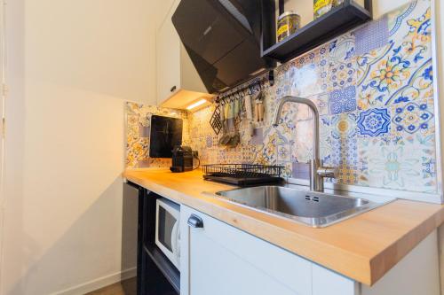 a kitchen with a sink and a counter top at Casa Remy in Cagliari