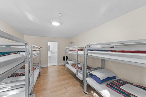 a room with four bunk beds in a room at Glendalough International Youth Hostel in Laragh