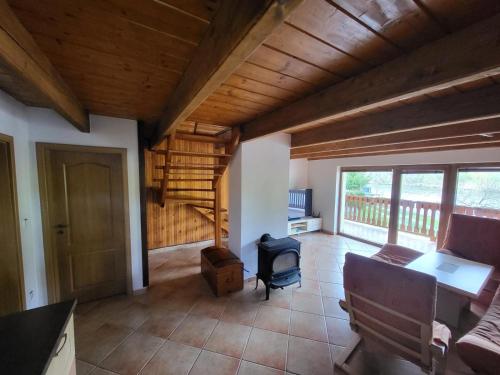 a living room with a couch and a wooden ceiling at Chata Lužnice in Koloděje nad Lužnicí