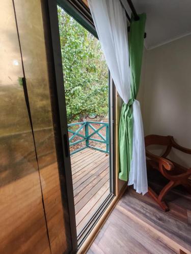 a glass door leading to a balcony with a wooden deck at Alojamiento Casa Guadalupe in San Felipe