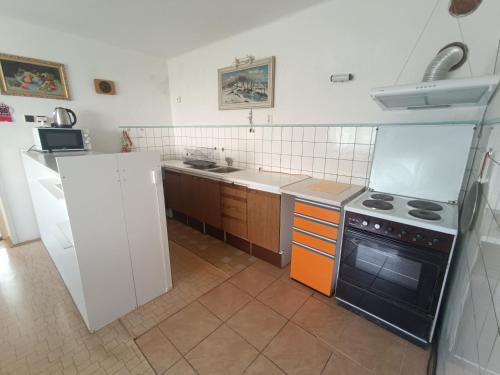 a small kitchen with a stove and a sink at Ubytovací zařízení Orlíček Černíkovice čp 145 in Černíkovice