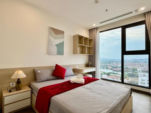 a bedroom with a bed and a large window at Vinhomes Sky Park Bac Giang by QMP in Bắc Giang