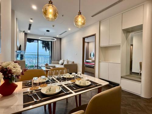 a dining room and living room with a table and chairs at Vinhomes Sky Park Bac Giang by QMP in Bắc Giang