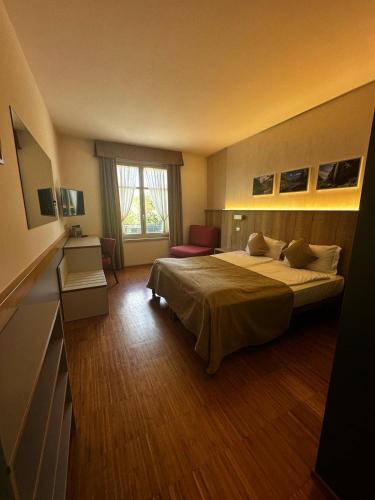 a hotel room with a bed and a window at Hotel Cortese in Armeno