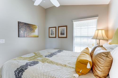 a bedroom with a bed with a lamp and a window at Village of Collier Retreat with Golf Cart and Lanai! in The Villages