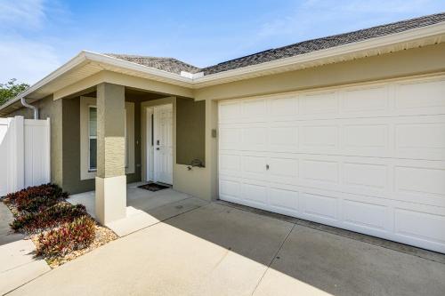a house with a white garage door at Village of Collier Retreat with Golf Cart and Lanai! in The Villages