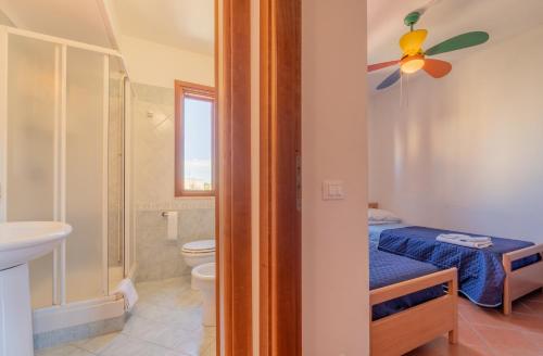 a bathroom with a bed and a toilet and a sink at Vista Mare e Castello Favignana in Favignana