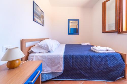 a bedroom with a bed and a table and a mirror at Vista Mare e Castello Favignana in Favignana