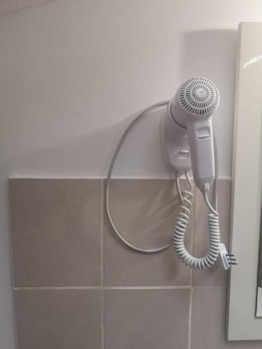 a blow dryer is attached to a wall in a bathroom at Le mie origini in Bagnoregio