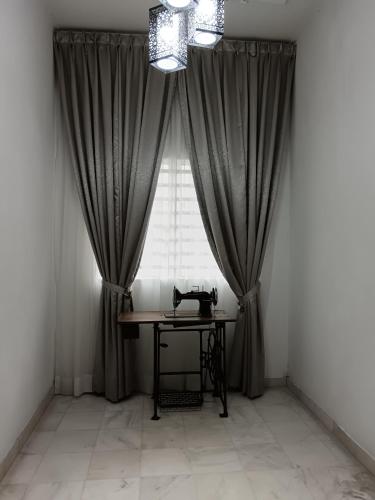 a room with a table in front of a window at Grey Fantasy Homes#Sunway Water Theme Park in Ipoh