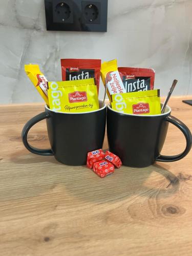 two cups filled with chips and candy on a table at Max stan na dan Doboj in Doboj