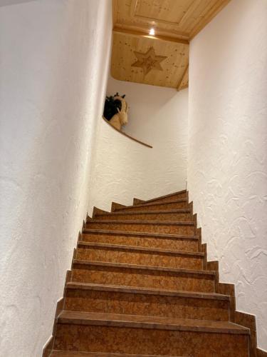 a staircase in a building with a stuffed animal on the wall at Ferienwohnung Datzmannlehen mit traumhaften Bergblick und Sauna in Ramsau