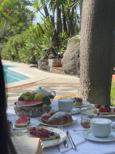a table with plates of food on top of it at B&B La Villa in Giardini Naxos