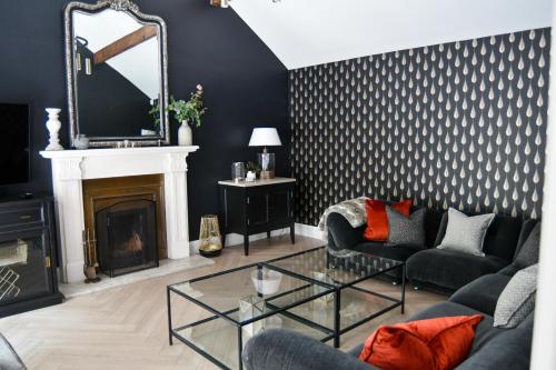 a living room with a couch and a fireplace at Luxury Croft Templepatrick Near Airport Rabbit and Hilton hotel in Templepatrick