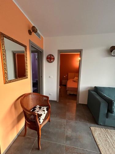 a living room with a couch and a chair at Alloggi CH40 in Imperia