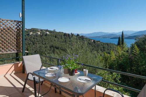 a table on a balcony with a view of the water at Agrili Sea View in Corfu