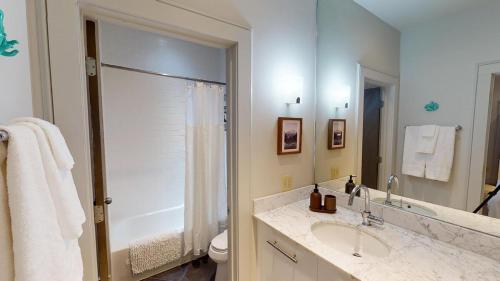 a bathroom with a sink and a shower and a toilet at Heart of Cloverdale Loft - Free Gated Parking in Montgomery