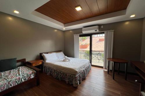 a small room with a bed and a window at Villa Minerva Eco-Farm Resort near Vigan in Fuerte