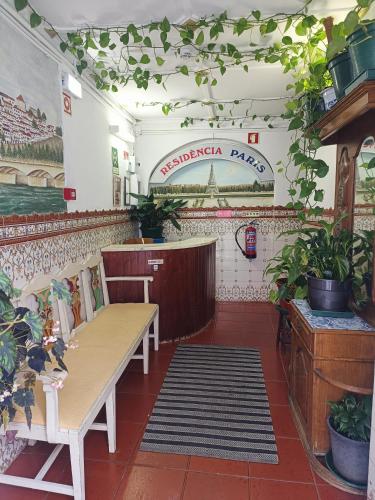 a restaurant with a table and benches in a room at Residencia Paris in Coimbra