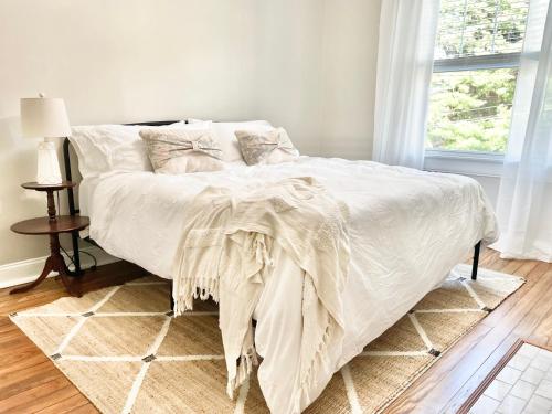 a bedroom with a bed with a blanket on it at 3 story, 100 year-old home, 4BR, 3 king & 2 queen beds in Pittsburgh