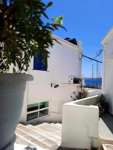 a white building with a view of the ocean at Matilda's studio in the port of Adamas in Adamas
