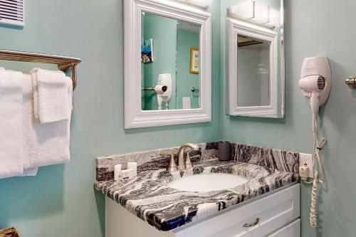 a bathroom with a sink and a mirror at #1131 The Mermaid Pad in Gulf Shores